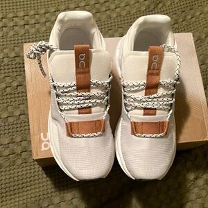 On Running White and Tan Athletic Shoes